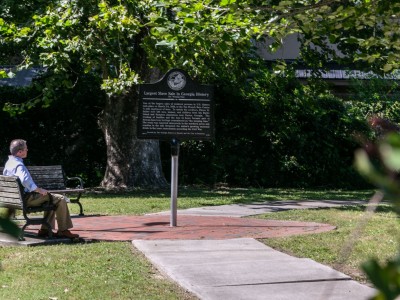 The Weeping Time Historic Marker in Savannah, Georgia A man looks at The Weeping Time Historic Marker in Savannah, Georgia